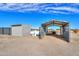 View of property's shed, trailer, and propane tank on a sunny day under a partly cloudy sky at 53974 W Barrel Rd, Maricopa, AZ 85139