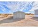 View of property's shed with metal doors on a sunny day under a partly cloudy sky at 53974 W Barrel Rd, Maricopa, AZ 85139