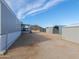 View of property's yard with adjacent buildings and mountain in the background on a sunny day at 53974 W Barrel Rd, Maricopa, AZ 85139