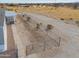 Aerial view of property's side yard with fence and partial view of home on a sunny day at 53974 W Barrel Rd, Maricopa, AZ 85139