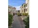 A view of the apartment complex with a pathway and flower beds at 5518 E Lindstrom Ln # 3012, Mesa, AZ 85215