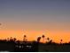 Scenic sunset view with silhouette of palm trees, creating a serene and picturesque landscape at 5518 E Lindstrom Ln # 3012, Mesa, AZ 85215