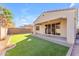 Private backyard with artificial grass, covered patio, paver accents, and a block fence at 5637 S 29Th Pl, Phoenix, AZ 85040