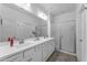 Bathroom featuring double sink vanity, large mirror and enclosed shower at 5637 S 29Th Pl, Phoenix, AZ 85040