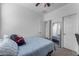 Bedroom featuring a bed, mirror, ceiling fan, and doors at 5637 S 29Th Pl, Phoenix, AZ 85040