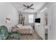 Cozy bedroom with ceiling fan, floral bedspread, closet, and decorative shelving at 5637 S 29Th Pl, Phoenix, AZ 85040