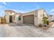 Charming home showcasing a two-car garage, turret entry and low maintenance desert landscaping at 5637 S 29Th Pl, Phoenix, AZ 85040