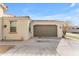 Exterior of home featuring attached two car garage and desert landscaping at 5637 S 29Th Pl, Phoenix, AZ 85040