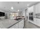 Open-concept kitchen featuring stainless steel appliances, granite countertops, and seamless flow to the living area at 5637 S 29Th Pl, Phoenix, AZ 85040