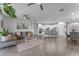 Open concept living room with modern kitchen, stainless appliances and gray wood-look flooring at 5637 S 29Th Pl, Phoenix, AZ 85040