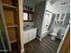 Well-lit bathroom with a shower-tub combo, vanity with sink, and storage options at 619 W Cocopah St, Phoenix, AZ 85003