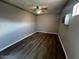 Cozy bedroom showcasing wood-look flooring, a ceiling fan, and a window for natural light at 619 W Cocopah St, Phoenix, AZ 85003