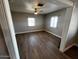 Inviting living room with wood-look floors, ceiling fan, and neutral paint at 619 W Cocopah St, Phoenix, AZ 85003