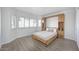 This bedroom has light-colored wooden floors, shuttered windows, and a built-in headboard with storage at 6315 E Kelton Ln, Scottsdale, AZ 85254