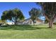 Charming single-story home featuring a well-manicured lawn and mature trees against a clear blue sky at 6315 E Kelton Ln, Scottsdale, AZ 85254