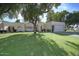 Charming home featuring a well-manicured front yard, mature shade trees, and an attached two-car garage at 6315 E Kelton Ln, Scottsdale, AZ 85254