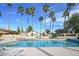 Sparkling community pool area lined with tall palm trees on a sunny day at 6315 E Kelton Ln, Scottsdale, AZ 85254