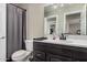 Bathroom with toilet, black faucet and vanity with framed mirror at 6405 W Saguaro Dr, Glendale, AZ 85304