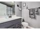 Updated bathroom with gray vanity, framed mirror and coordinating towels at 6405 W Saguaro Dr, Glendale, AZ 85304