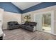 Comfortable living room with a vaulted ceiling, wood floors, sliding glass door and modern decor at 6405 W Saguaro Dr, Glendale, AZ 85304