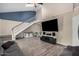 Inviting living room with a staircase, wood floors and a high ceiling, perfect for relaxation and entertainment at 6405 W Saguaro Dr, Glendale, AZ 85304