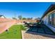 An outdoor patio features a dining set and putting green, ideal for entertaining in a stylish backyard space at 6420 N 85Th Pl, Scottsdale, AZ 85250