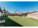 A green backyard offers space for outdoor activities, including a putting green and relaxation area for entertaining at 6420 N 85Th Pl, Scottsdale, AZ 85250