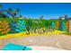 A vibrant 'Play In...Scottsdale' mural adds a playful touch to the backyard decor, and the desert landscape at 6420 N 85Th Pl, Scottsdale, AZ 85250