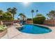 An in-ground pool with spa surrounded by lush landscaping and a brick fence creates a private outdoor oasis at 6420 N 85Th Pl, Scottsdale, AZ 85250