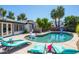 Inviting pool with lounge chairs surrounded by lush landscaping and clear blue water at 6420 N 85Th Pl, Scottsdale, AZ 85250