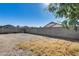 Expansive dirt backyard is enclosed by a block wall, creating privacy and plenty of space at 6557 W Puget Ave, Glendale, AZ 85302