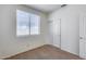 Bedroom with a closet, carpeted floors, and a window, providing comfort and functionality at 6557 W Puget Ave, Glendale, AZ 85302