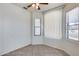 Bright, sunny bedroom with neutral tile flooring and a ceiling fan at 6557 W Puget Ave, Glendale, AZ 85302