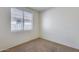 Cozy bedroom with neutral walls, carpeted floors, and a bright window, creating a peaceful retreat at 6557 W Puget Ave, Glendale, AZ 85302