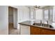 Kitchen island with stainless steel sink and dishwasher in a brightly lit space at 6557 W Puget Ave, Glendale, AZ 85302