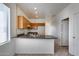 Well-lit kitchen with oak cabinets, tile floors and functional appliances at 6557 W Puget Ave, Glendale, AZ 85302