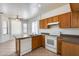 Kitchen with white appliances and tile flooring at 6557 W Puget Ave, Glendale, AZ 85302