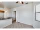 Open-plan living area with tile flooring, lots of natural light, and adjacent kitchen at 6557 W Puget Ave, Glendale, AZ 85302