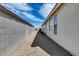 Narrow side yard with stucco walls, a concrete block fence, and potential for landscaping or storage at 6557 W Puget Ave, Glendale, AZ 85302