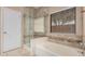 A newly remodeled bathroom with a glass shower door and a tiled backsplash at 6640 W Honeysuckle Dr, Phoenix, AZ 85083
