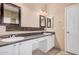 A bathroom with double sinks, granite countertops, and decorative mirrors at 6640 W Honeysuckle Dr, Phoenix, AZ 85083