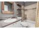 Bathroom featuring a tub and shower combo, granite counters, and rustic wood accents at 6640 W Honeysuckle Dr, Phoenix, AZ 85083