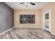 A spacious bedroom with neutral walls, and a door to the outdoor area at 6640 W Honeysuckle Dr, Phoenix, AZ 85083