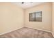 A bedroom with neutral walls, neutral carpet, and a window at 6640 W Honeysuckle Dr, Phoenix, AZ 85083