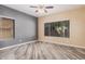 A spacious bedroom with neutral walls, and wood-look flooring at 6640 W Honeysuckle Dr, Phoenix, AZ 85083