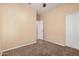 A bedroom with neutral walls, neutral carpet, and a built-in closet at 6640 W Honeysuckle Dr, Phoenix, AZ 85083