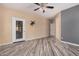 A bedroom with neutral walls, a door to the outdoor area, and an open closet at 6640 W Honeysuckle Dr, Phoenix, AZ 85083