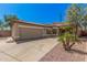 Tan single-story home with a desert-landscaped front yard, concrete driveway and a two-car garage at 6640 W Honeysuckle Dr, Phoenix, AZ 85083