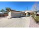 Well-maintained home featuring a spacious driveway, two-car garage, desert landscaping, and a welcoming entrance at 6640 W Honeysuckle Dr, Phoenix, AZ 85083