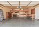 Spacious garage with painted floor, built-in shelving for storage, and ample workspace at 6640 W Honeysuckle Dr, Phoenix, AZ 85083